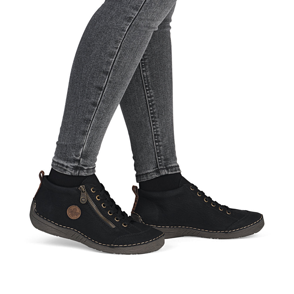 Rieker 52514-00 women's black zip & lace shoe boots, on-foot lifestyle view.