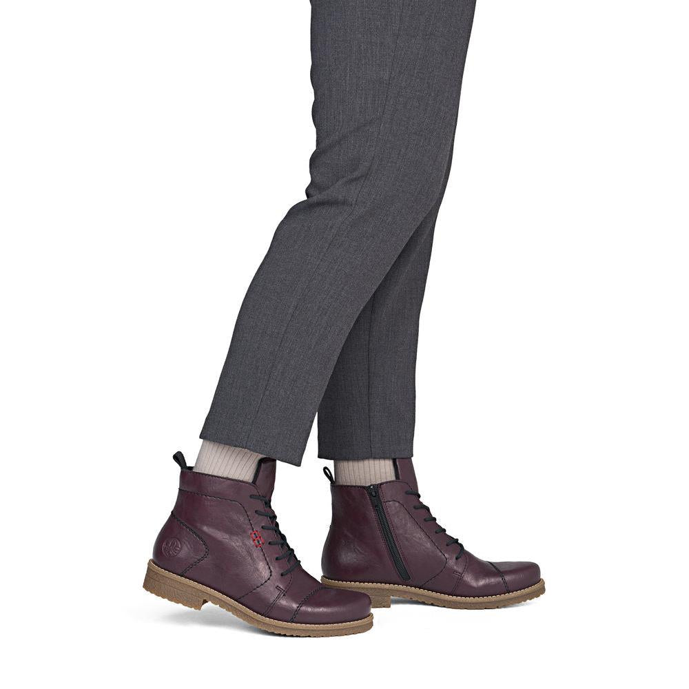 Rieker 73500-30 women's burgundy zip & lace ankle boots, on-foot lifestyle view.