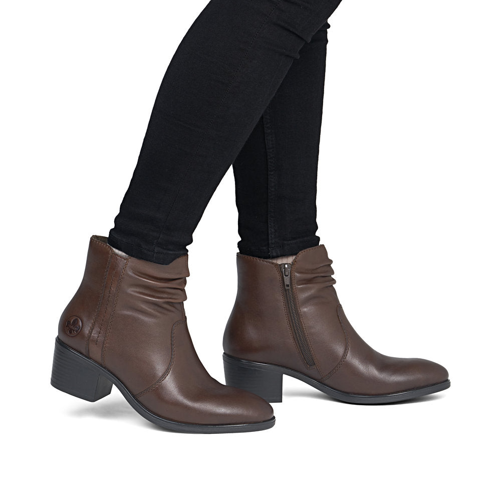 Rieker 73953-27 women's brown leather side zip ankle boots, on-foot lifestyle view.