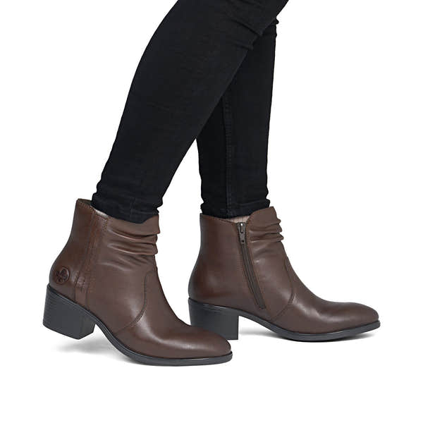 Rieker 73953-27 women's brown leather side zip ankle boots, on-foot lifestyle view.