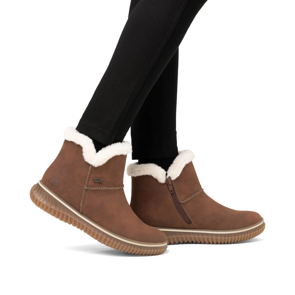 Rieker 74260-25 women's brandy water resistant slip on ankle boots, on-foot lifestyle view.