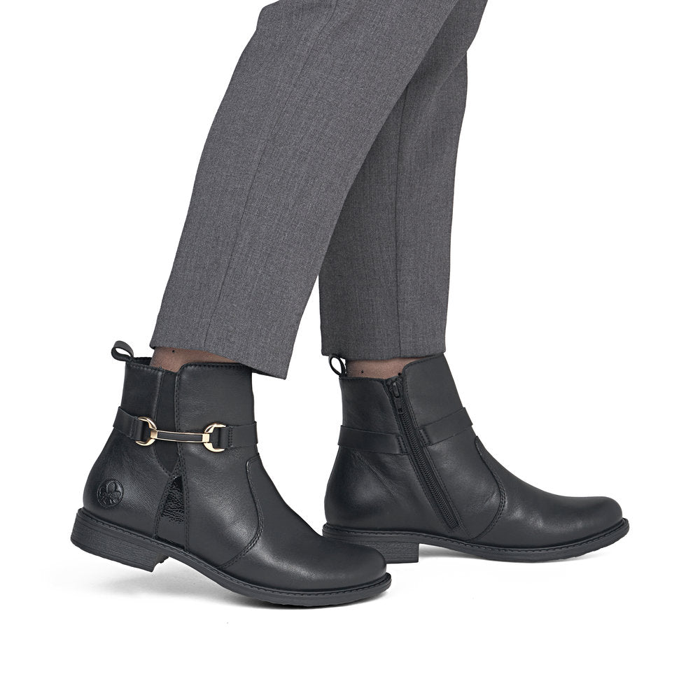 Rieker 74856-00 women's wide black leather side zip ankle boots, on-foot lifestyle view.