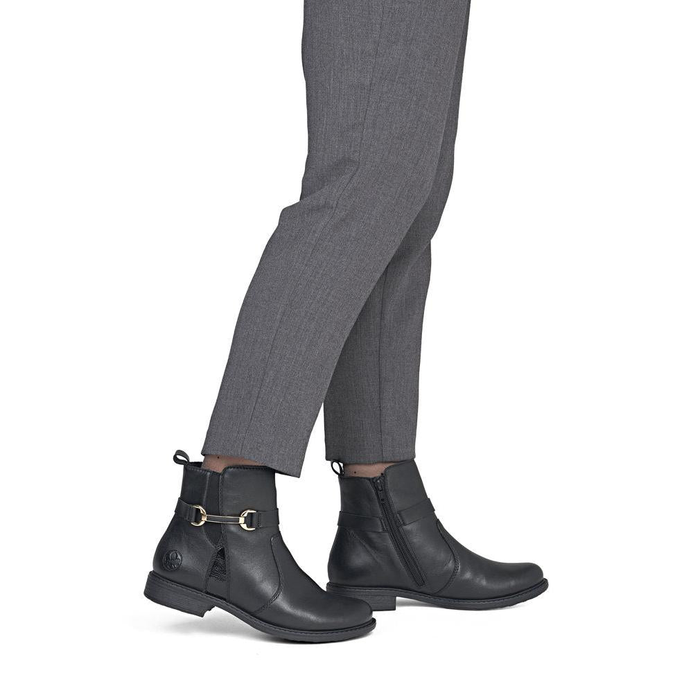 Rieker 74856-00 women's wide black leather side zip ankle boots, on-foot lifestyle view.