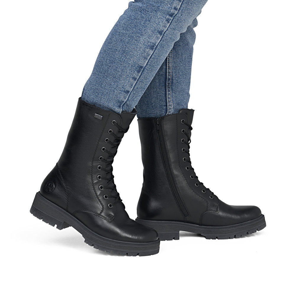 Rieker 75801-00 women's wide black leather water resistant zip & lace ankle boots, on-foot lifestyle view.