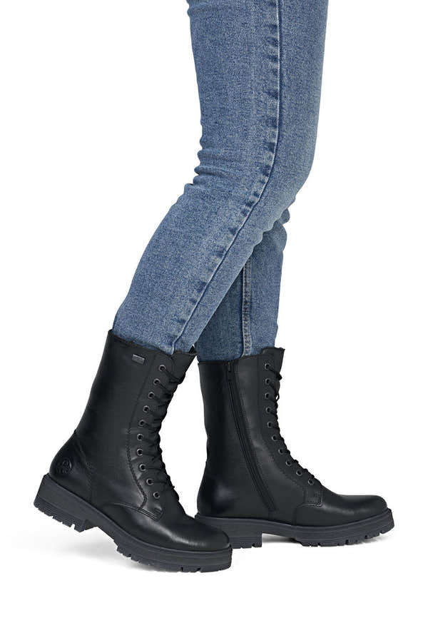 Rieker 75801-00 women's wide black leather water resistant zip & lace ankle boots, on-foot lifestyle view.