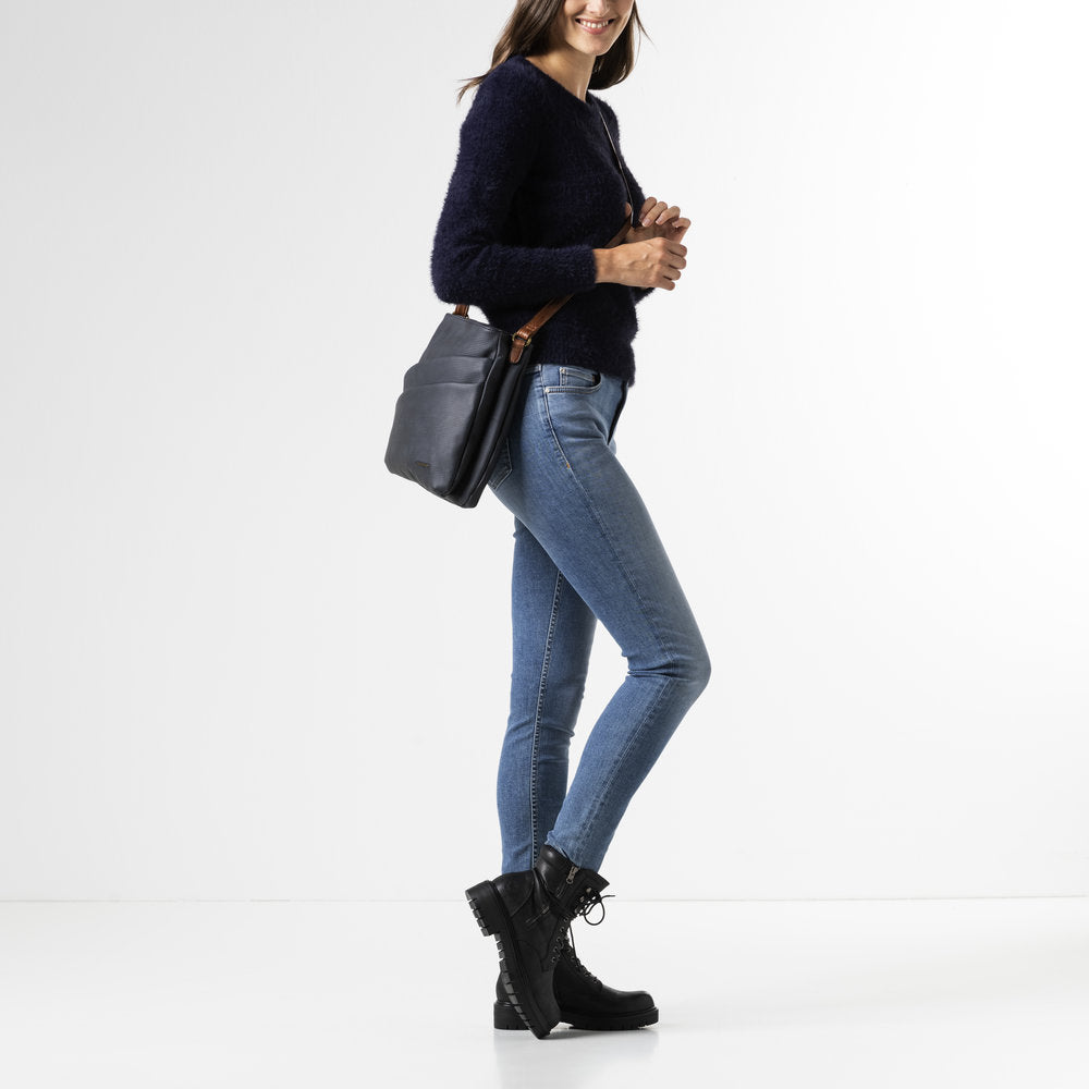Rieker H1005-14 women's navy handbag with cross over tan strap, front view.