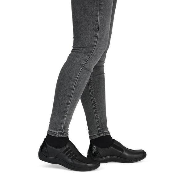 Rieker L1777-00 women's black leather slip on shoes, on-foot lifestyle view.