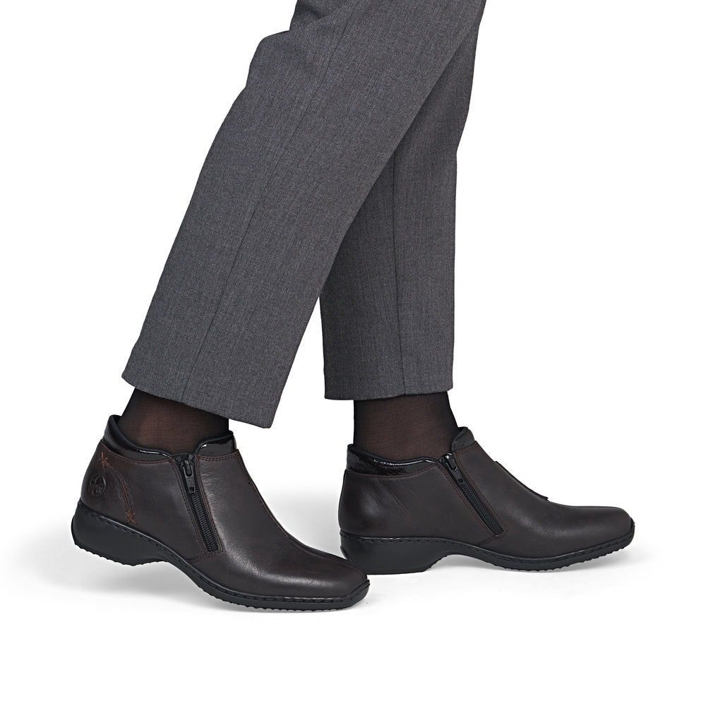 Rieker L3882-25 women's narrow brown leather side zip ankle boots, on-foot lifestyle view.