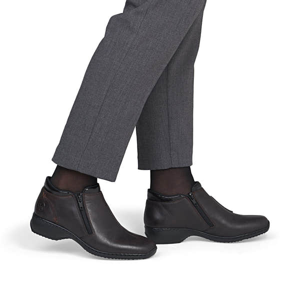 Rieker L3882-25 women's narrow brown leather side zip ankle boots, on-foot lifestyle view.