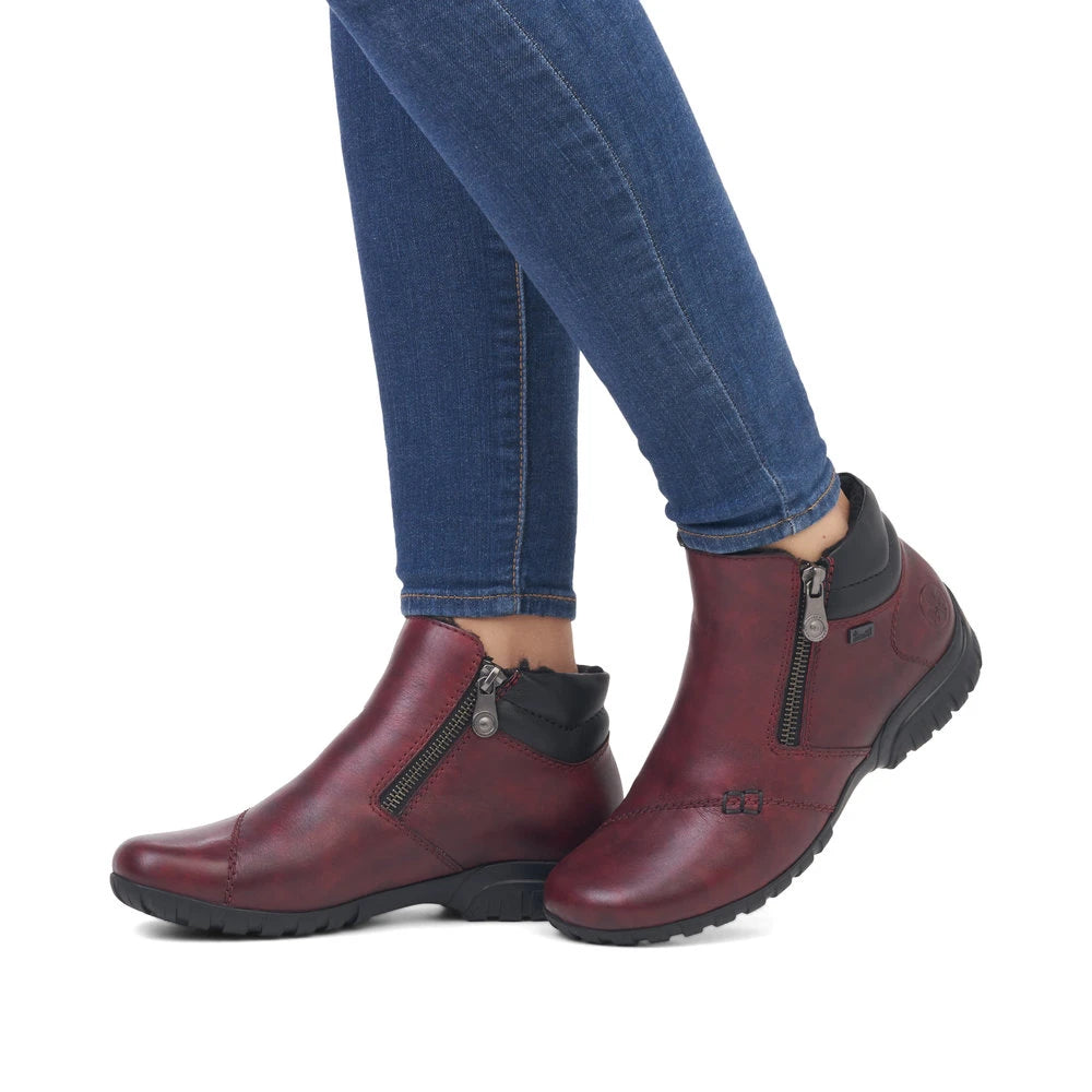 Rieker L4655-35 women's wide red leather water resistant side zip ankle boots, on-foot lifestyle view.