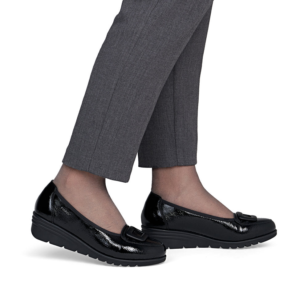 Rieker L5362-00 women's black slip on shoes, on-foot lifestyle view.