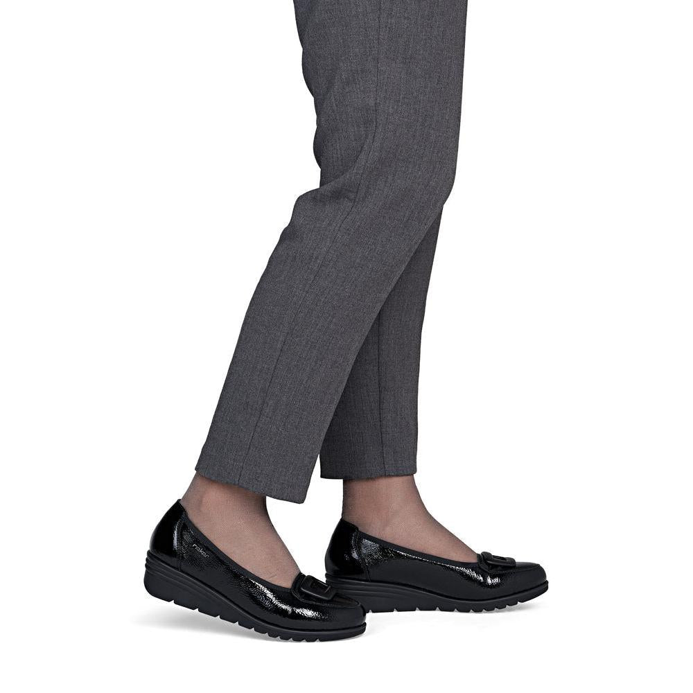 Rieker L5362-00 women's black slip on shoes, on-foot lifestyle view.