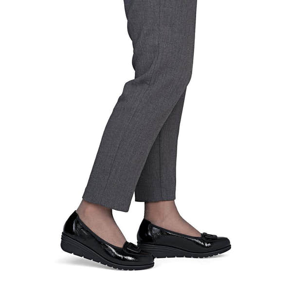 Rieker L5362-00 women's black slip on shoes, on-foot lifestyle view.
