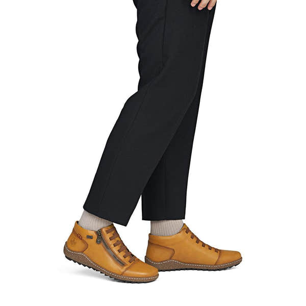 Rieker L7563-68 women's narrow brown leather water resistant side zip shoes, on-foot lifestyle view.