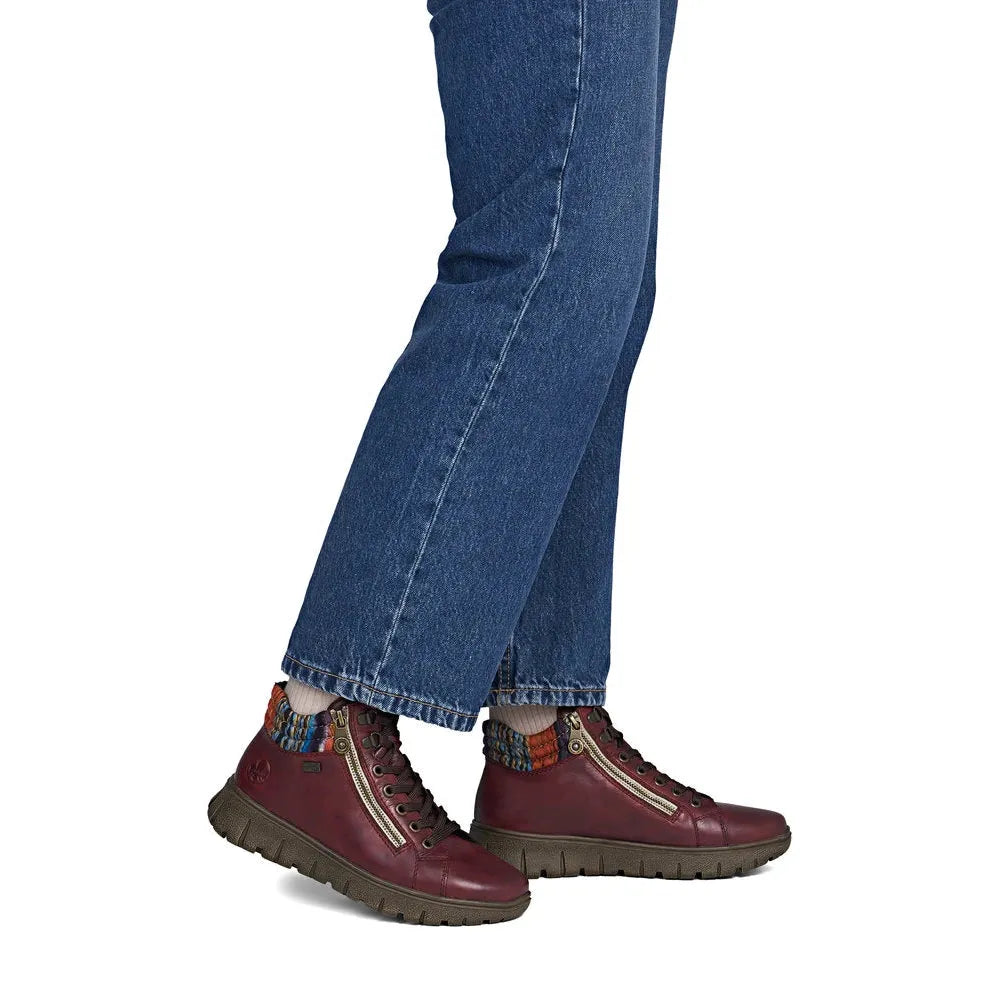 Rieker N1305-35 women's red leather zip & lace ankle boots, on-foot lifestyle view.