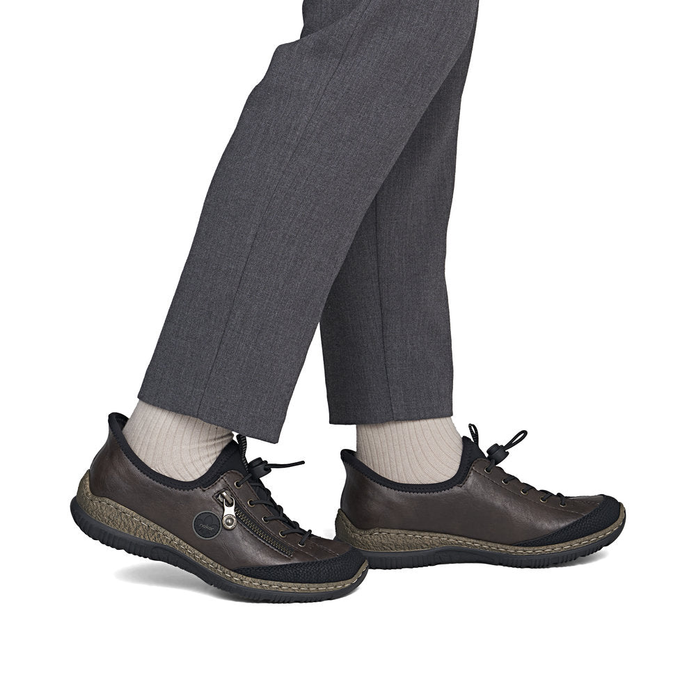Rieker N3267-25 women's black elasticated shoes, on-foot lifestyle view.