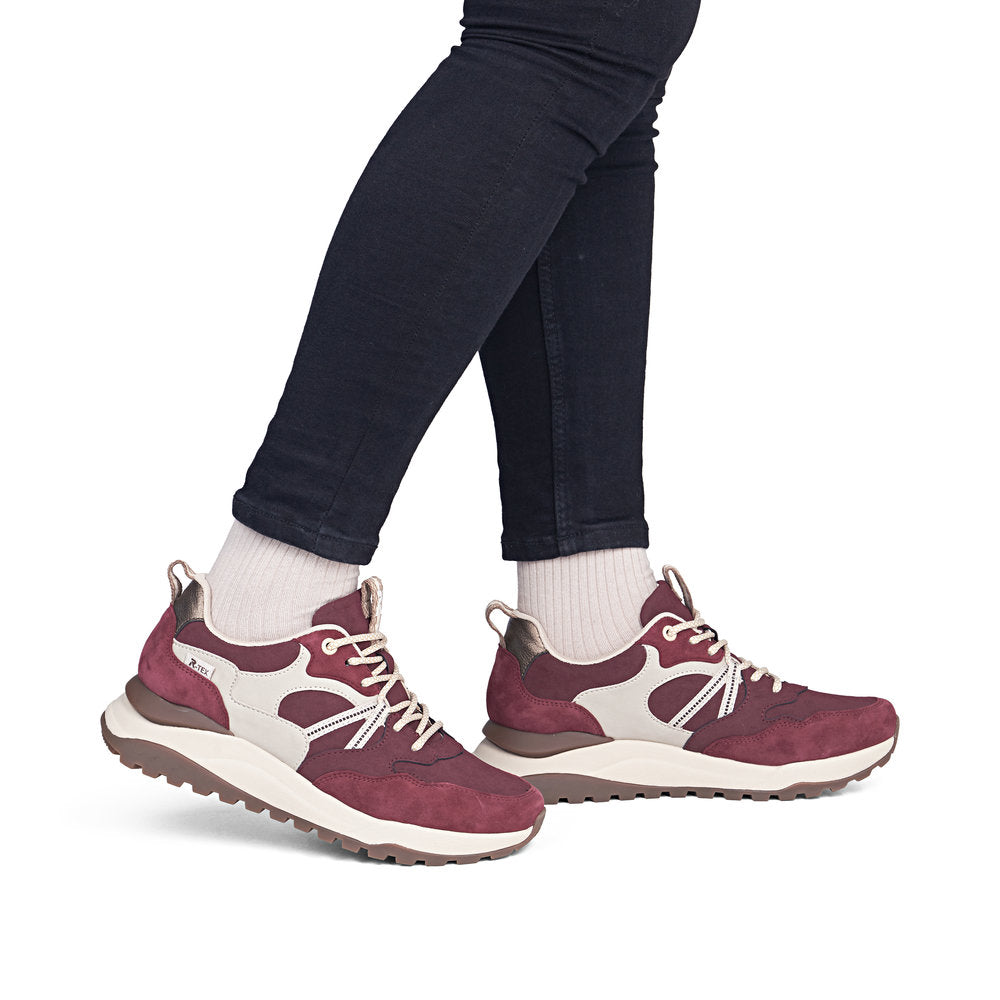 Rieker W2501-35 women's bordeaux leather water resistant lace up trainers, on-foot lifestyle view.