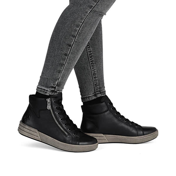 Rieker X0709-01 women's black leather zip & lace ankle boots, on-foot lifestyle view.
