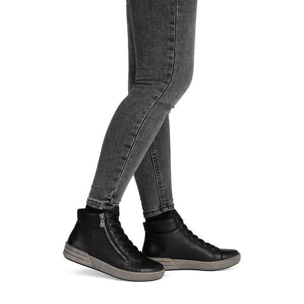 Rieker X0709-01 women's black leather zip & lace ankle boots, on-foot lifestyle view.