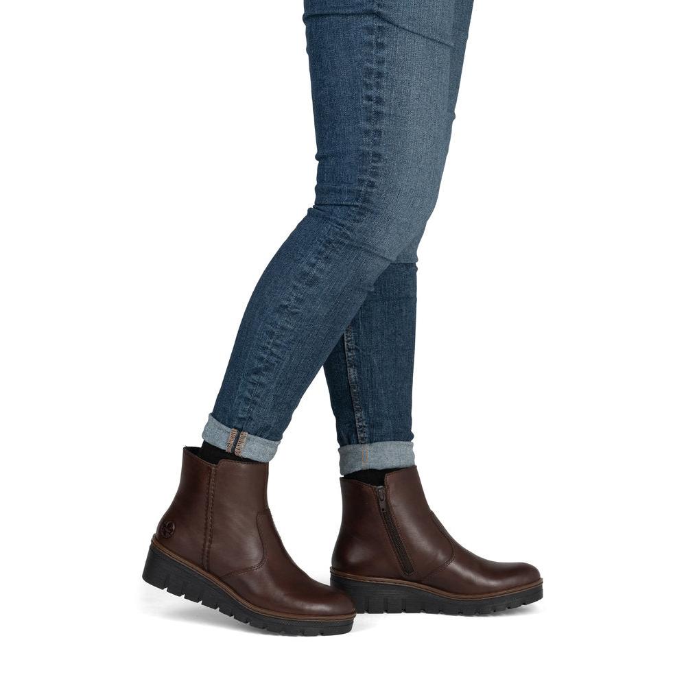 Rieker X9165-27 women's brown leather side zip ankle boots, on-foot lifestyle view.