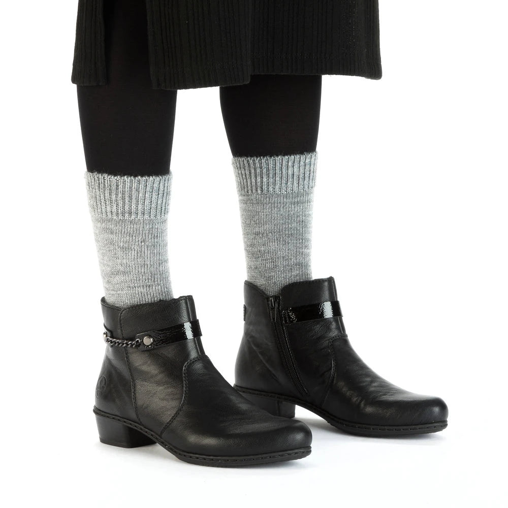 Rieker Y0783-00 women's black side zip ankle boots, on-foot lifestyle view.