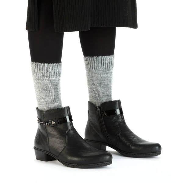 Rieker Y0783-00 women's black side zip ankle boots, on-foot lifestyle view.