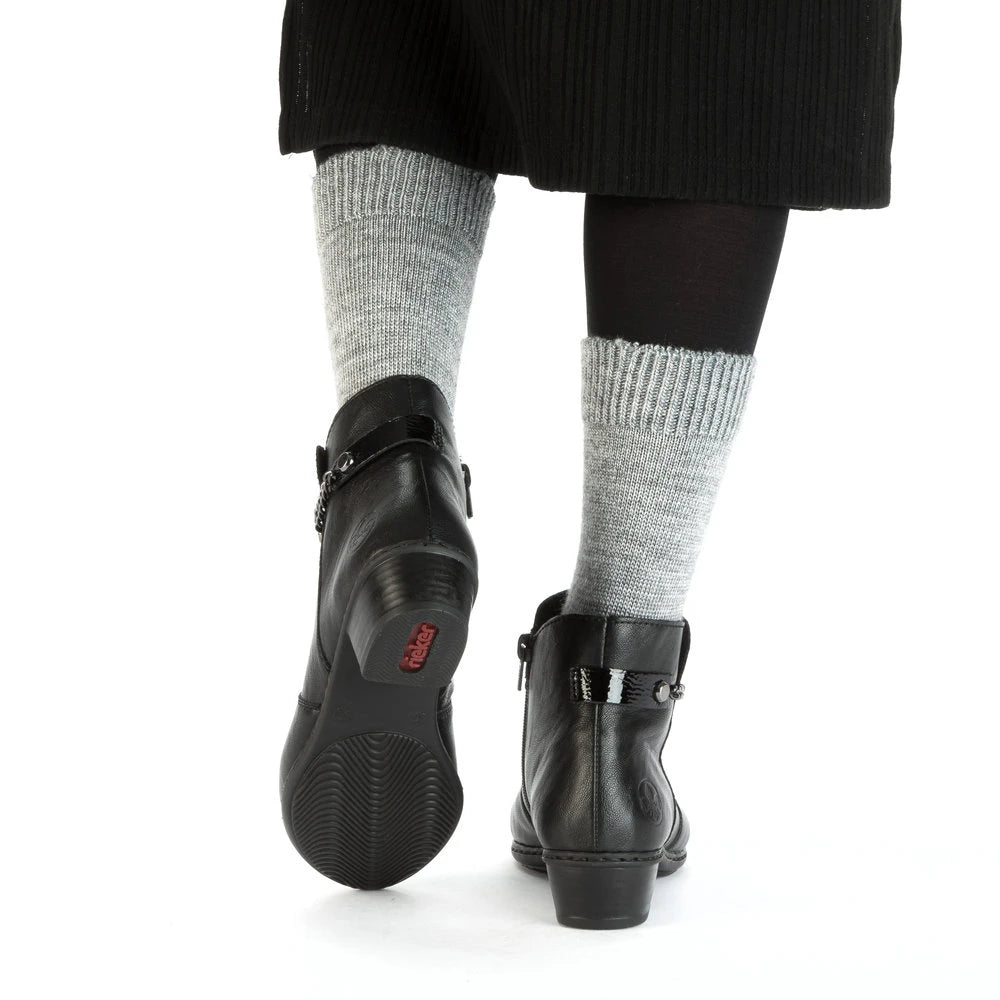 Rieker Y0783-00 women's black side zip ankle boots, lifestyle view 3 of 4.