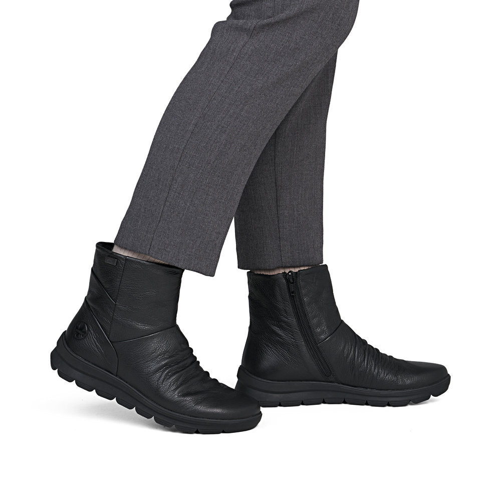Rieker Z0066-00 women's black leather water resistant side zip ankle boots, on-foot lifestyle view.