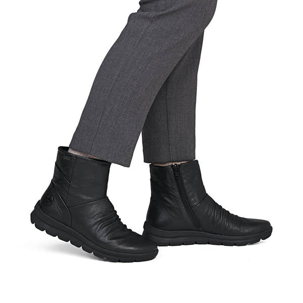 Rieker Z0066-00 women's black leather water resistant side zip ankle boots, on-foot lifestyle view.