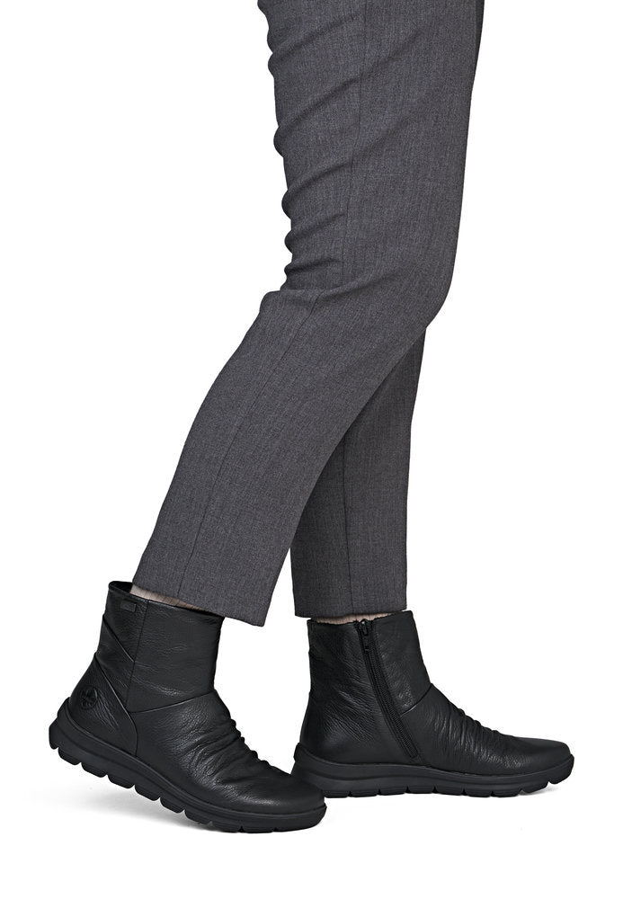Rieker Z0066-00 women's black leather water resistant side zip ankle boots, on-foot lifestyle view.