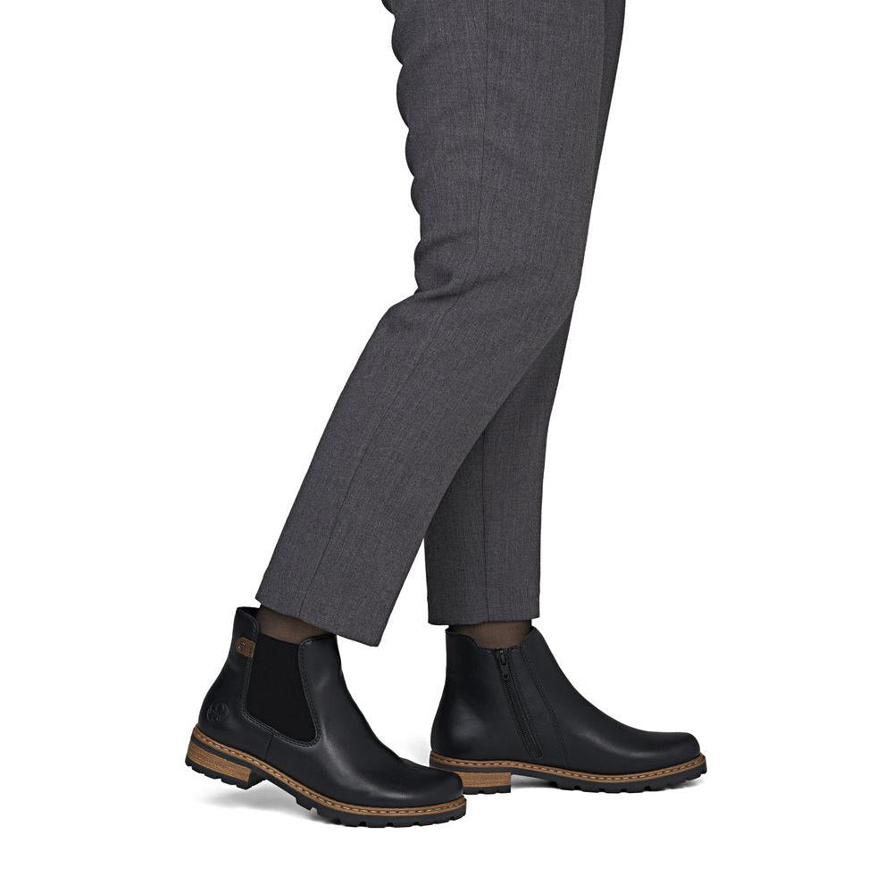 Rieker Z9340-00 women's black zip & lace ankle boots, on-foot lifestyle view.