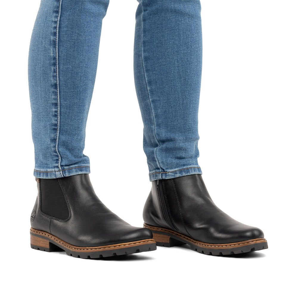 Rieker Z9354-00 women's black side zip ankle boots, on-foot lifestyle view.