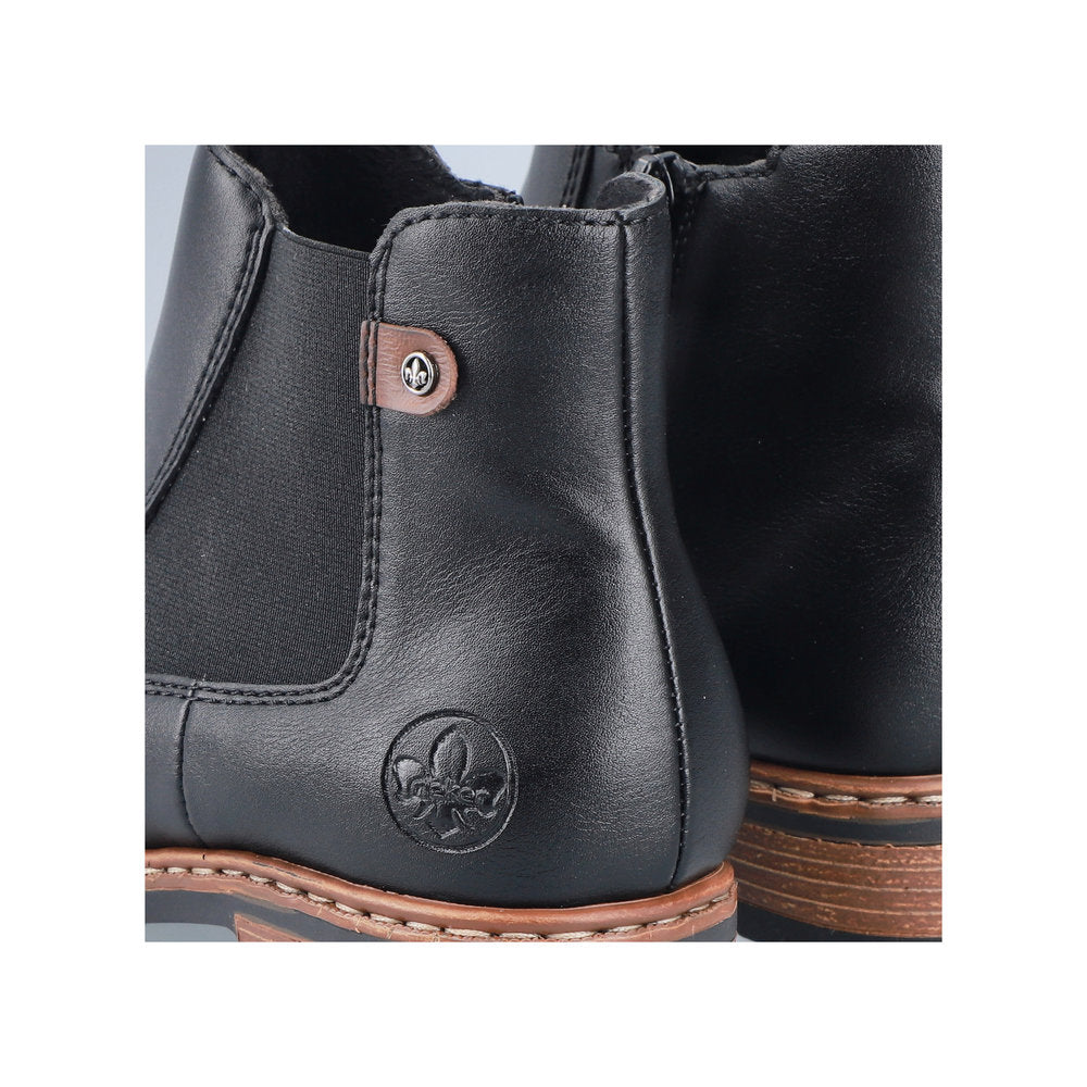 Rieker Z9354-00 women's black side zip ankle boots, lifestyle view.