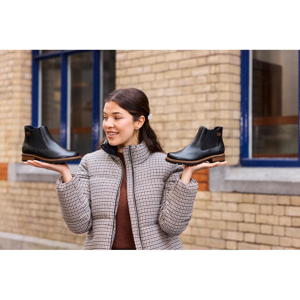 Rieker Z9354-00 women's black side zip ankle boots, lifestyle view 6 of 8.