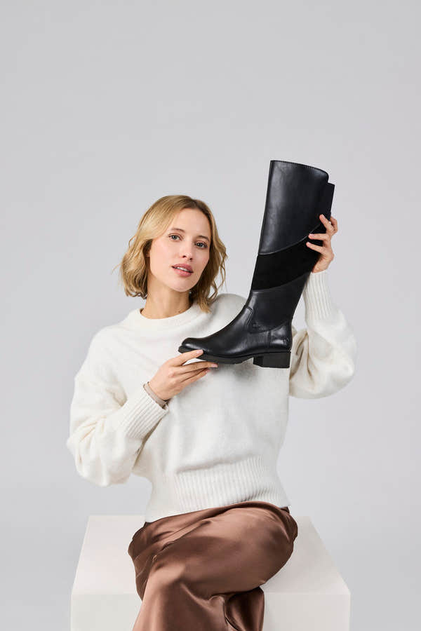 Rieker Z9566-00 women's black leather water resistant side zip knee high boots, lifestyle view 1 of 4.