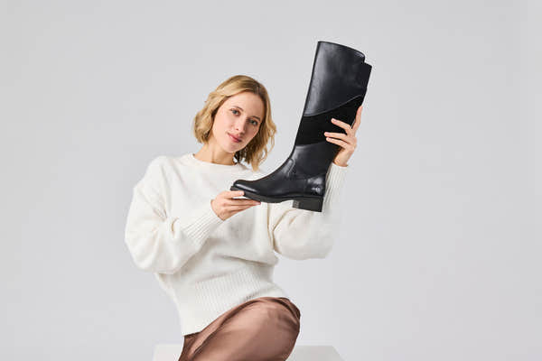 Rieker Z9566-00 women's black leather water resistant side zip knee high boots, lifestyle view 2 of 4.