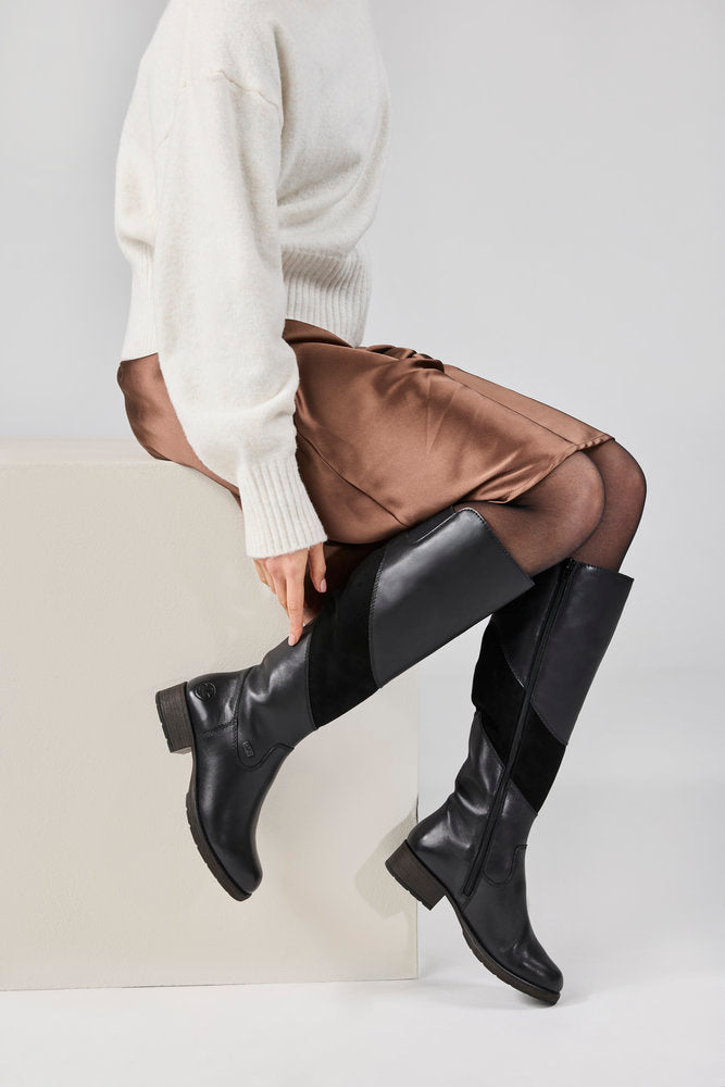 Rieker Z9566-00 women's black leather water resistant side zip knee high boots, lifestyle view 3 of 4.
