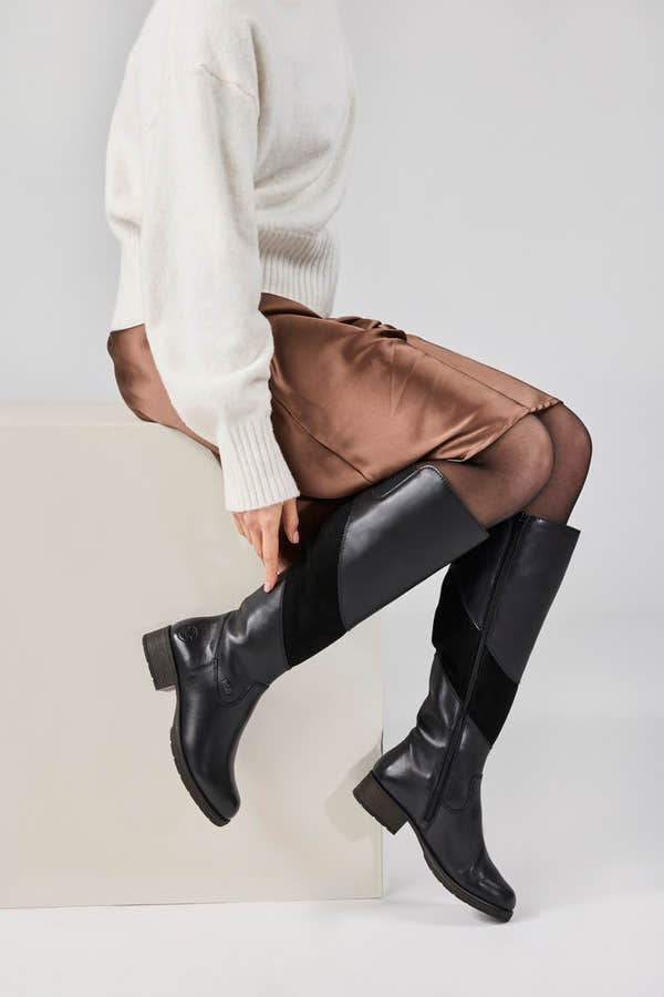 Rieker Z9566-00 women's black leather water resistant side zip knee high boots, lifestyle view 3 of 4.