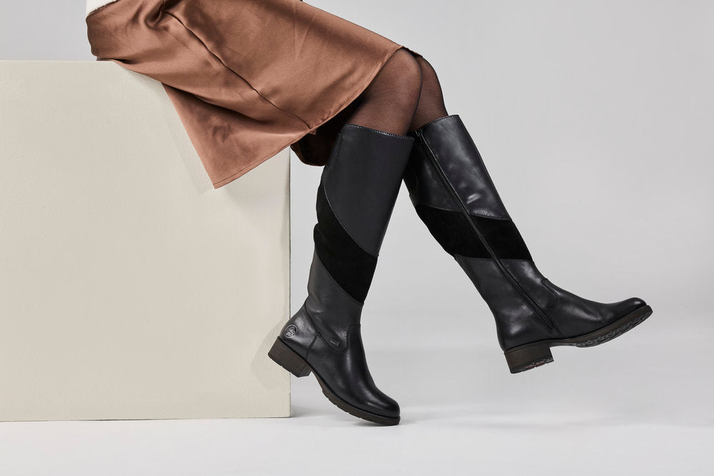 Rieker Z9566-00 women's black leather water resistant side zip knee high boots, lifestyle view 4 of 4.