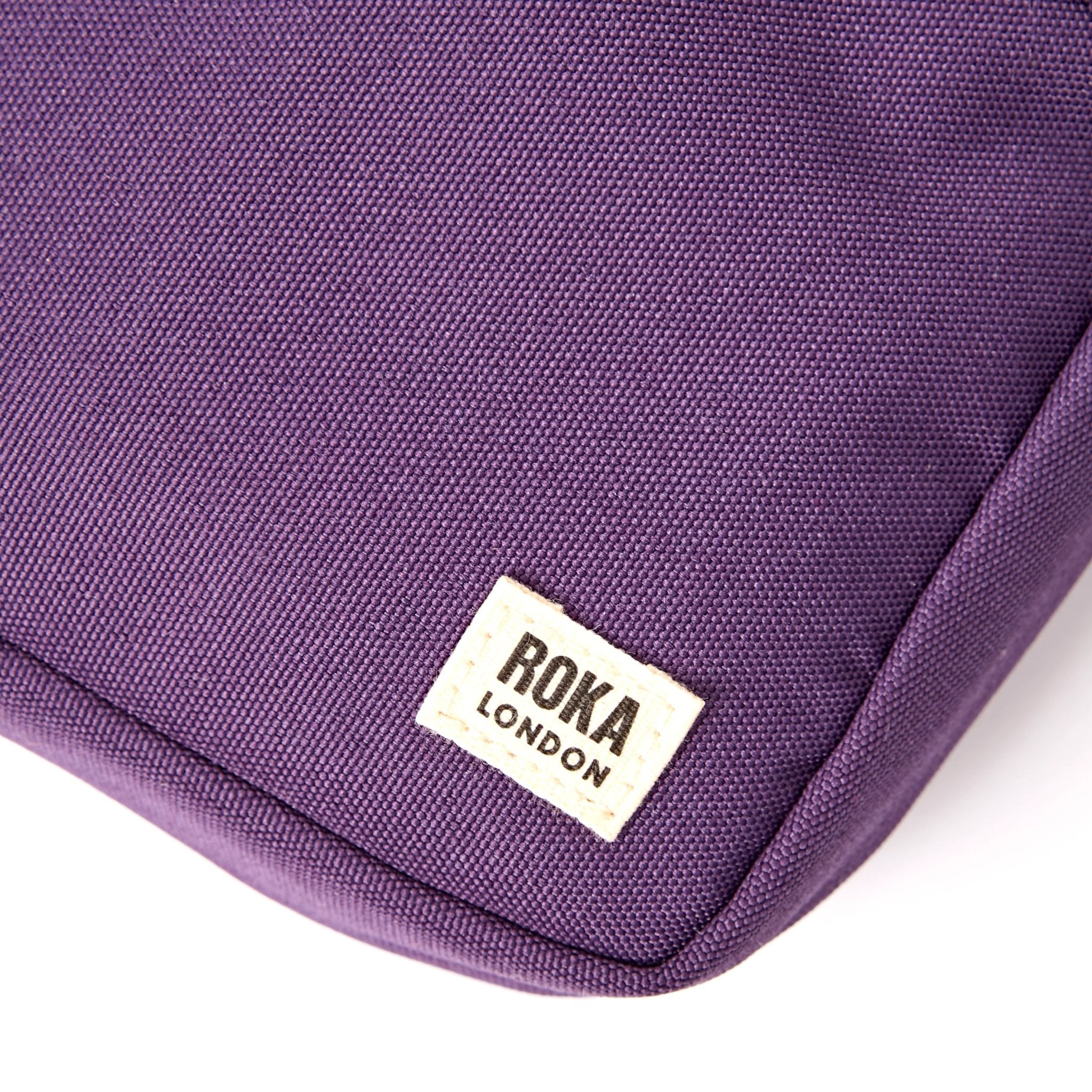 Roka Bond Deep Grape Recycled Canvas Crossbody Bag, brand label detail.