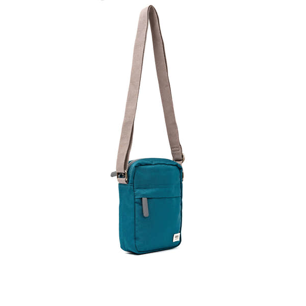 Roka Bond Deep Teal Recycled Canvas Crossbody Bag, side view.