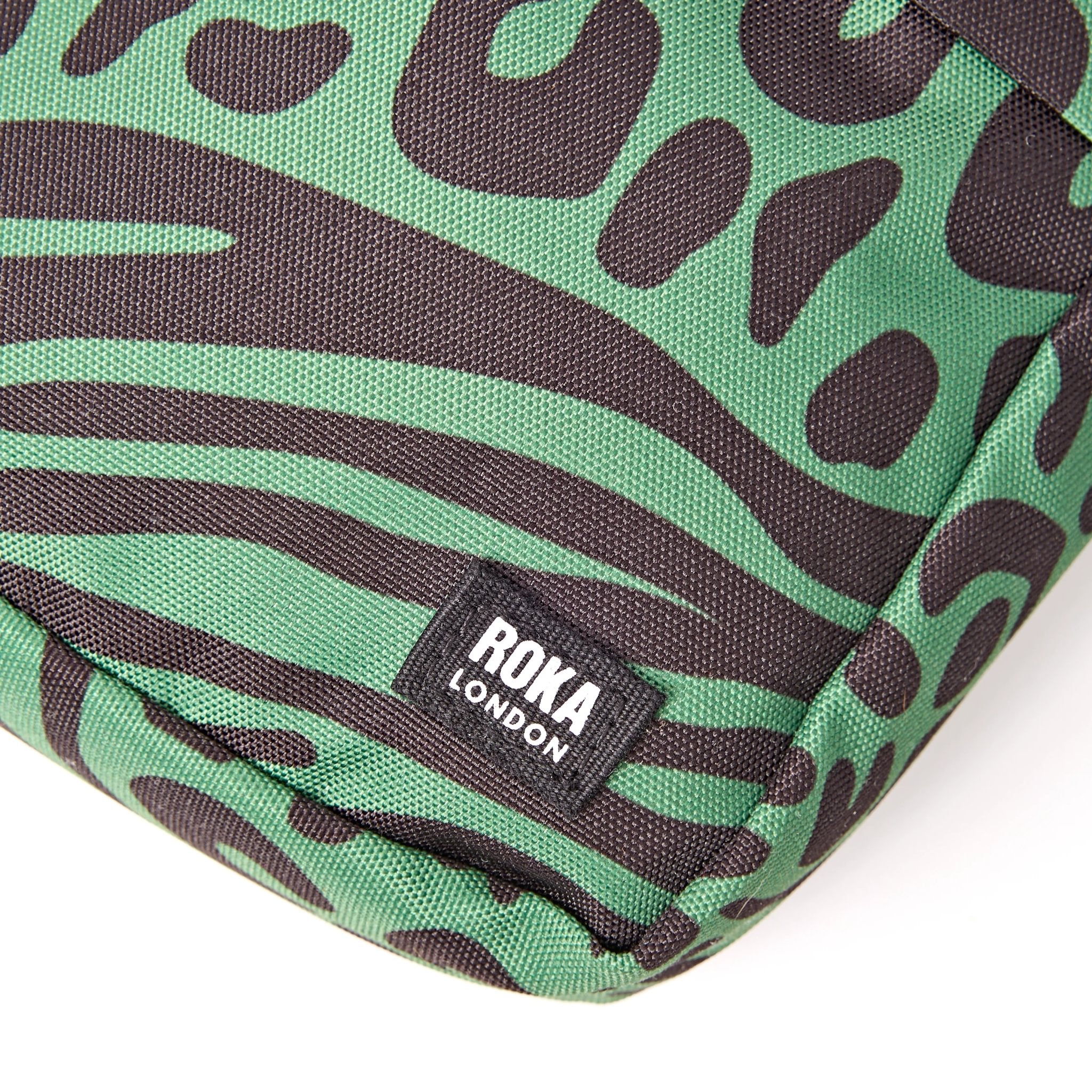 Roka Bond Mixed Animal Artichoke Recycled Canvas Crossbody Bag, brand label detail.