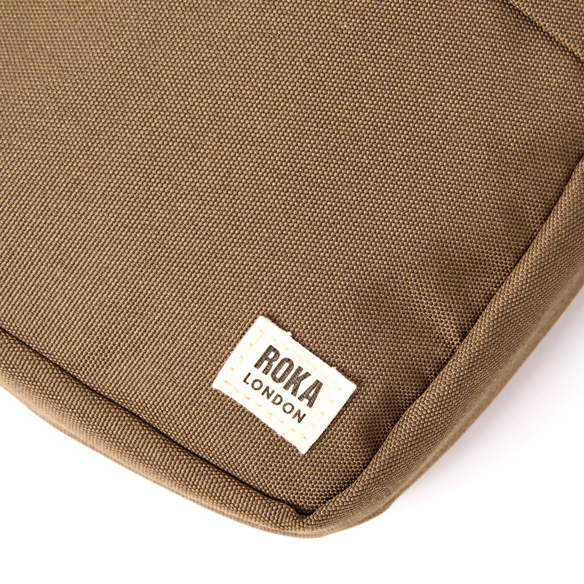 Roka Bond Sea Spray Recycled Canvas Crossbody Bag, brand label detail.