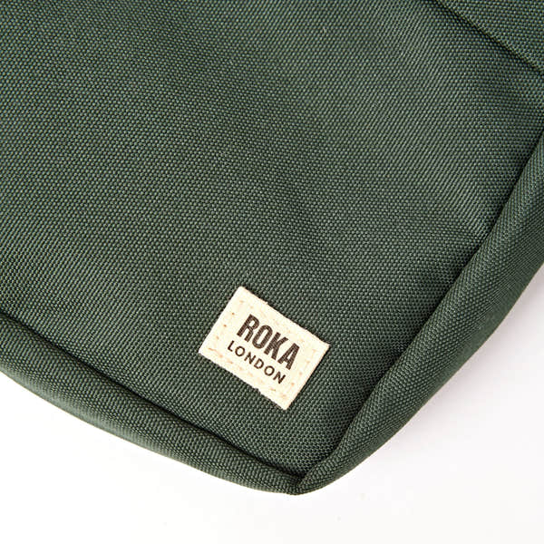 Roka Bond Thunderstorm Recycled Canvas Crossbody Bag, brand label detail.