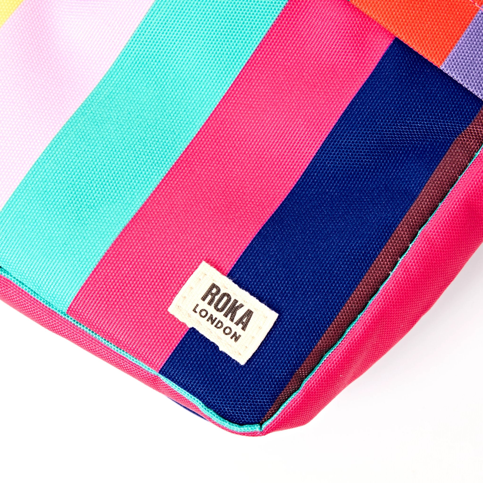 Roka Bond Wide Multi Stripe Recycled Canvas Crossbody Bag, brand label detail.