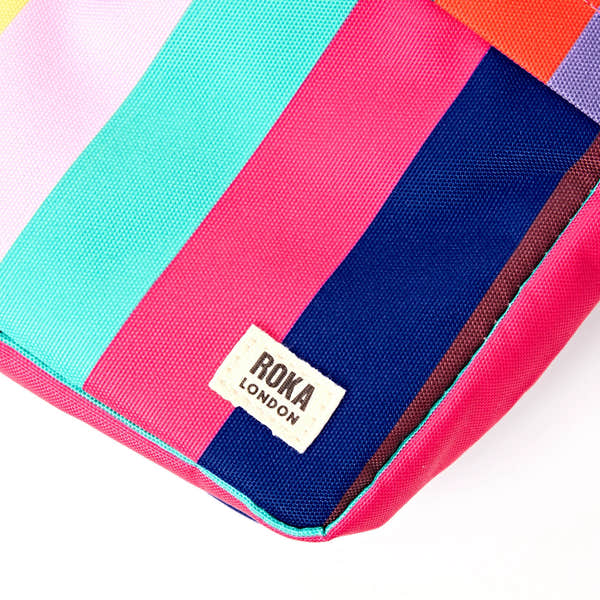 Roka Bond Wide Multi Stripe Recycled Canvas Crossbody Bag, brand label detail.