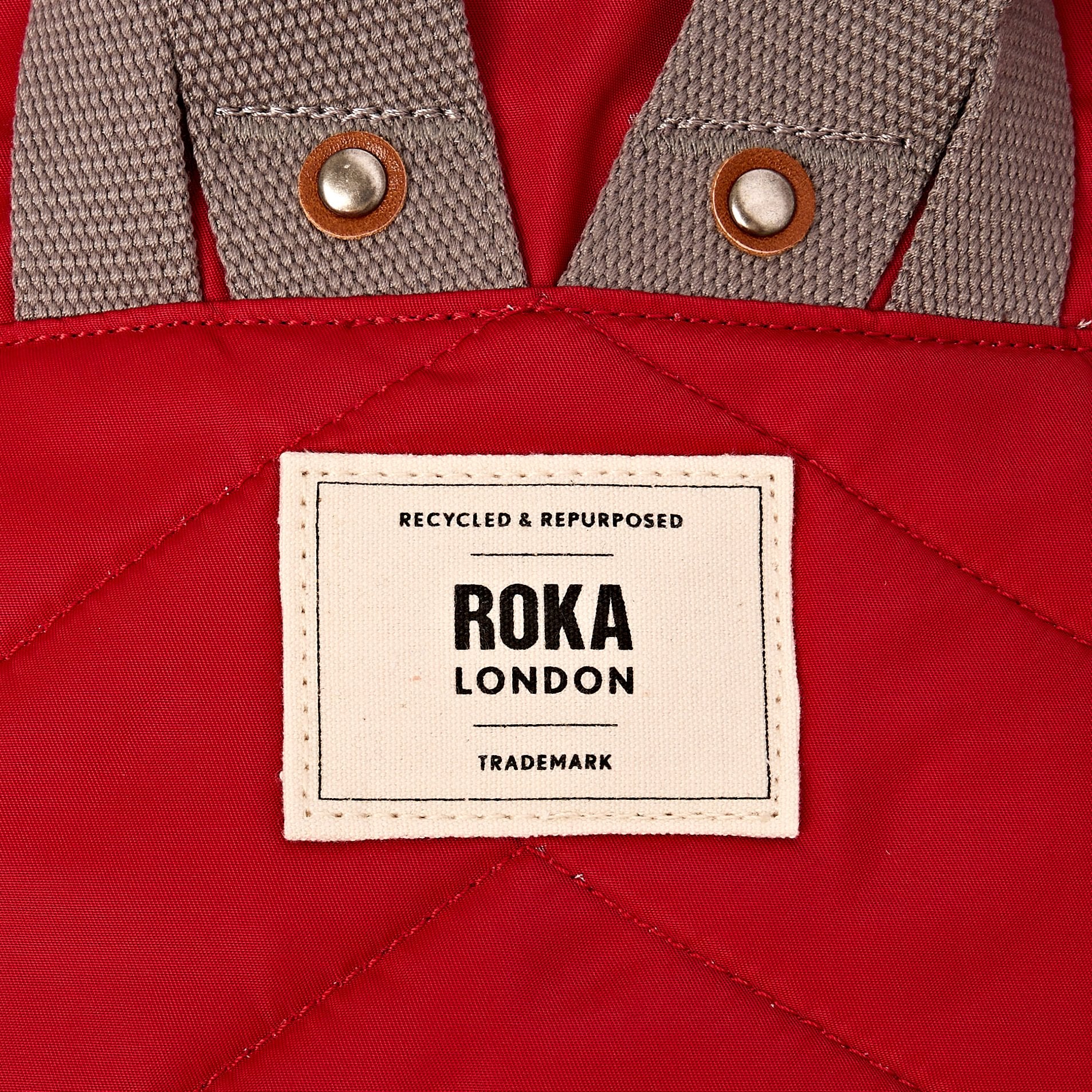 Roka Canfield B Sustainable Nylon Cranberry, brand label detail.