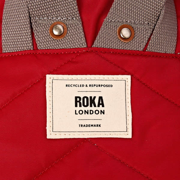 Roka Canfield B Sustainable Nylon Cranberry, brand label detail.