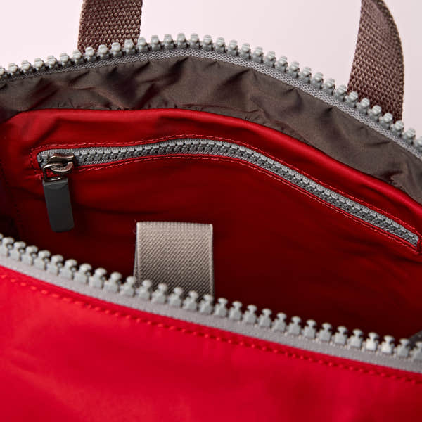 Roka Canfield B Sustainable Nylon Cranberry, side view.