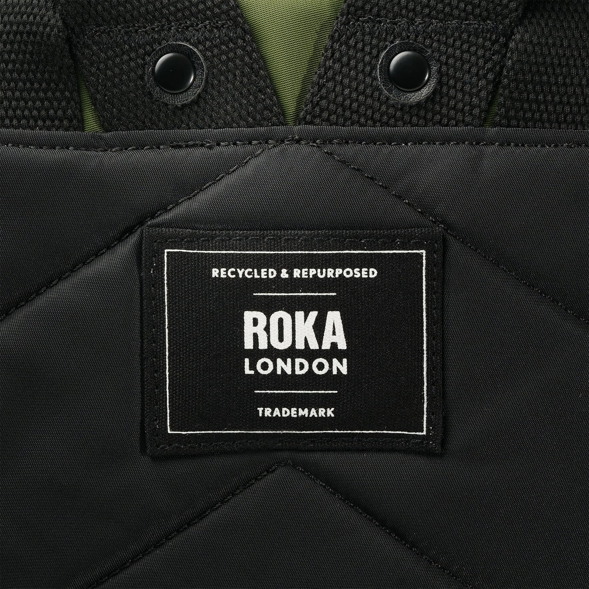 Roka Canfield Medium Avocado Recycled Nylon Backpack, brand label detail.
